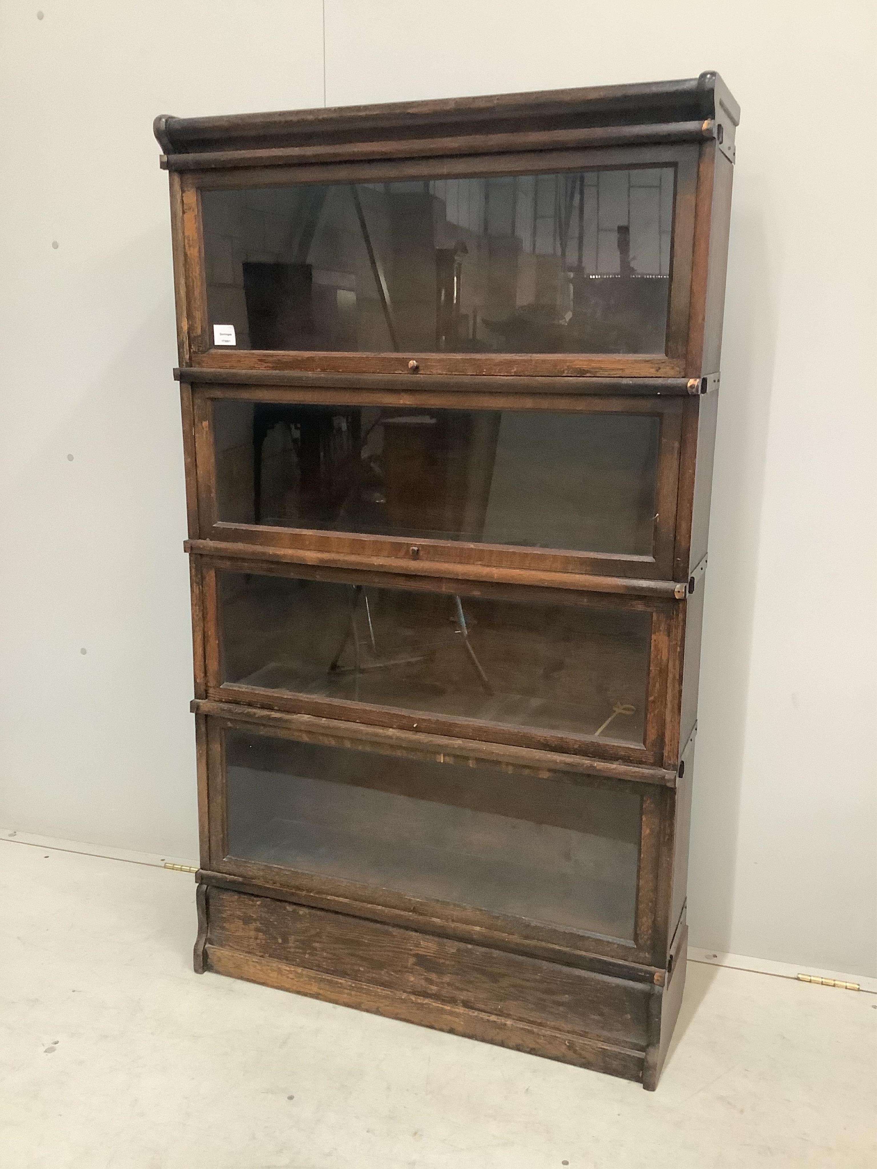 A Globe Wernicke oak four section bookcase, width 86cm, depth 27cm, height 151cm. Condition - fair